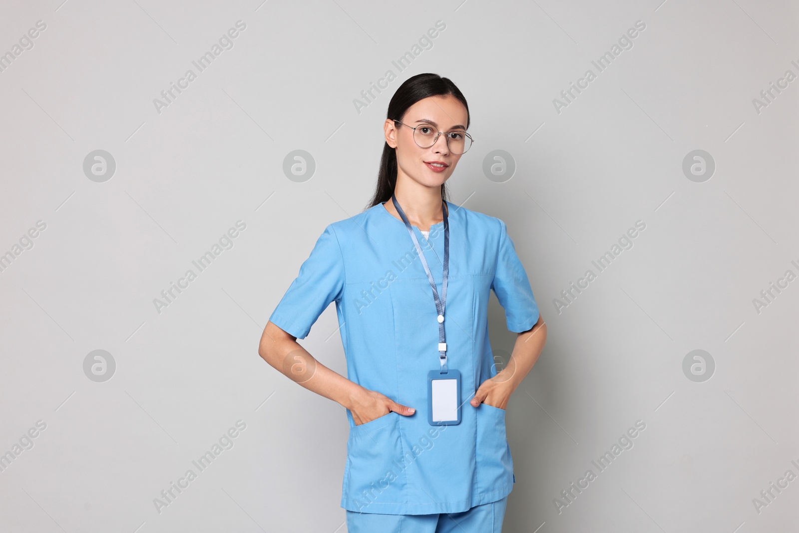 Photo of Portrait of beautiful nurse on grey background