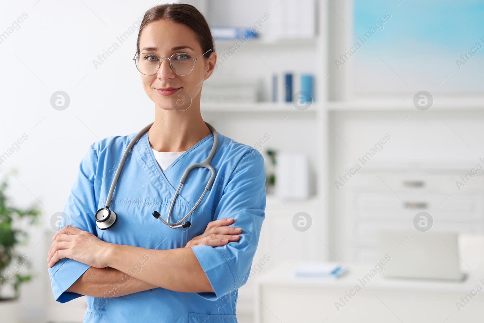 Photo of Nurse in medical uniform with stethoscope indoors, space for text