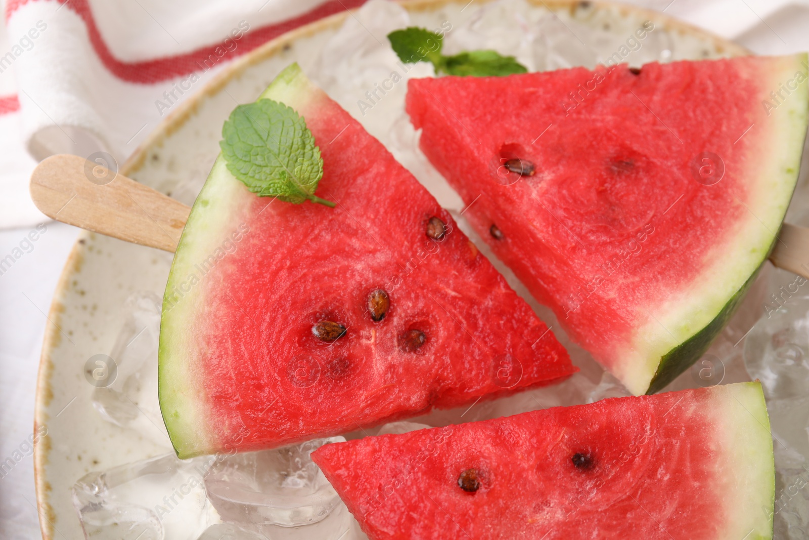 Photo of Pieces of tasty watermelon, ice cubes and mint on table, top view