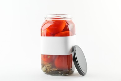 Tasty pickled tomatoes in jar on white background