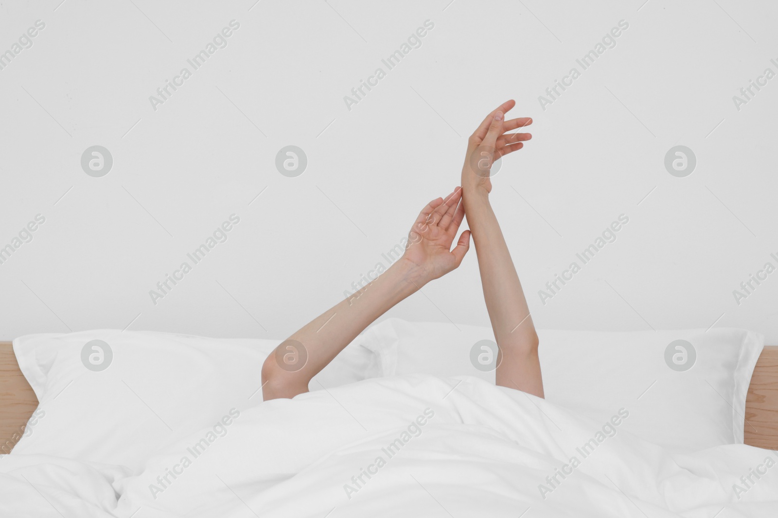 Photo of Bedtime. Woman lying in bed indoors, closeup