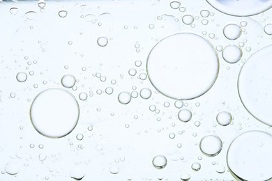 Photo of Sample of cosmetic oil on white background, macro view