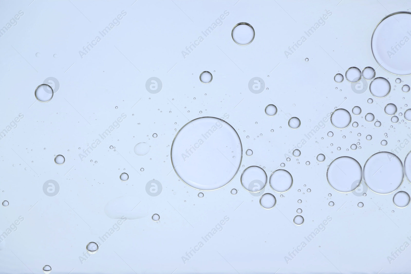 Photo of Sample of cosmetic oil on white background, macro view