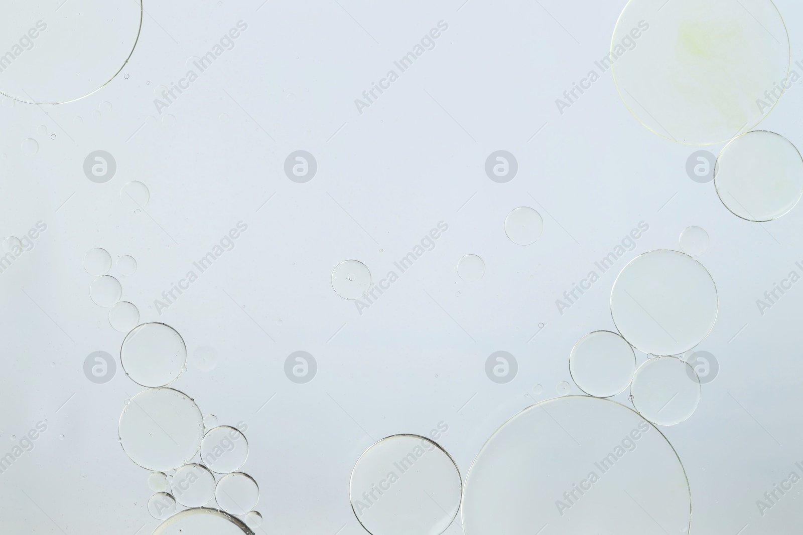 Photo of Sample of cosmetic oil on white background, macro view