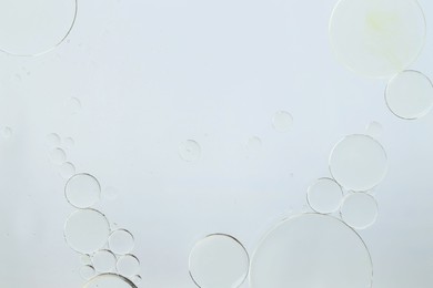 Photo of Sample of cosmetic oil on white background, macro view