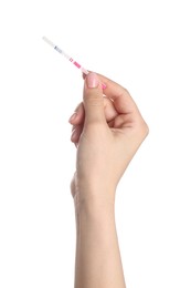 Woman holding pregnancy test on white background, closeup