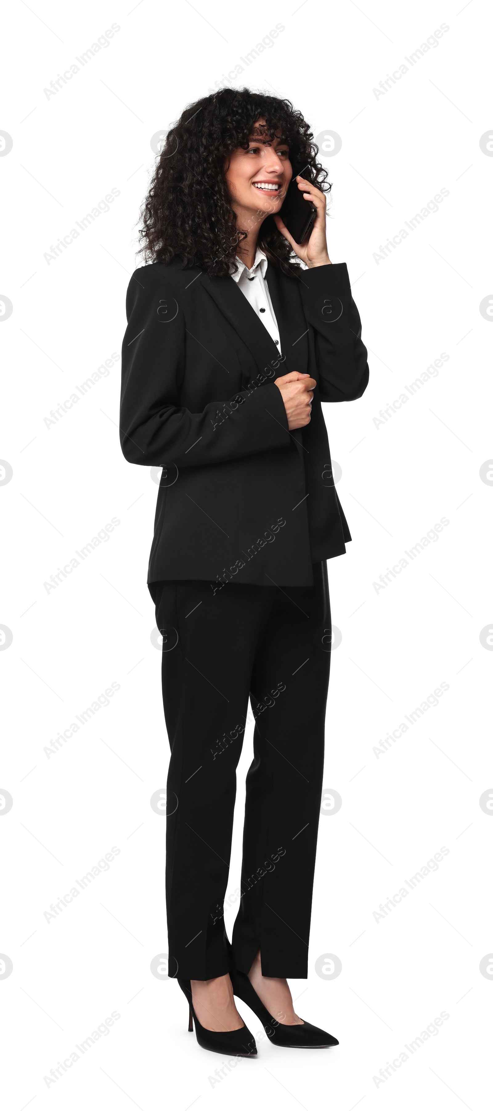 Photo of Beautiful young woman in black suit talking on smartphone against white background