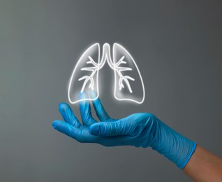 Image of Doctor holding virtual lungs on grey background, closeup