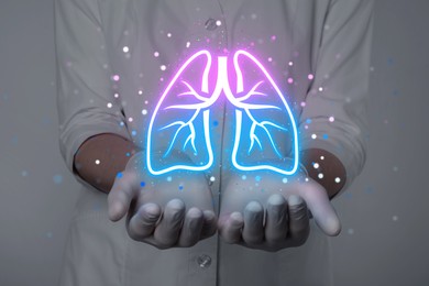 Image of Doctor holding virtual lungs on grey background, closeup