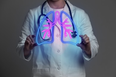 Image of Doctor holding virtual lungs on grey background, closeup