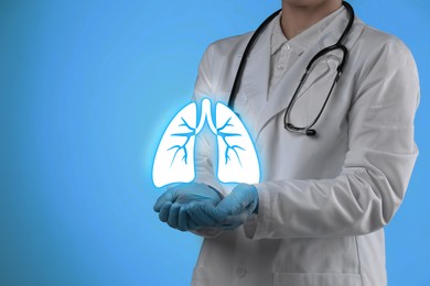 Image of Doctor holding virtual lungs on light blue background, closeup