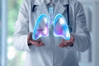 Image of Doctor holding virtual lungs in clinic, closeup