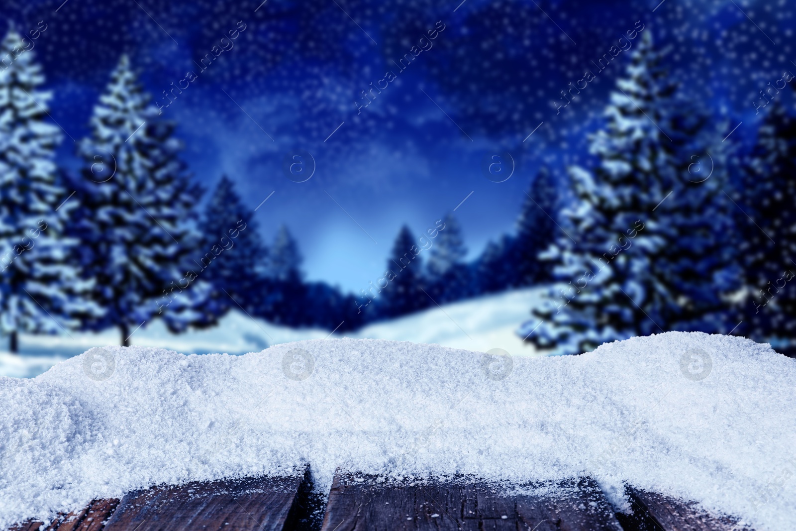 Image of Wooden table with snow in forest, space for text