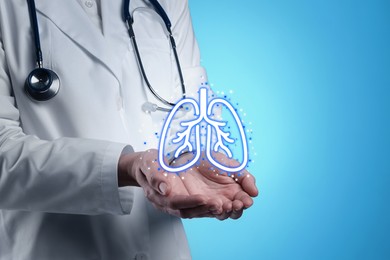 Image of Doctor holding virtual lungs on light blue background, closeup