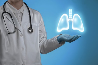 Image of Doctor holding virtual lungs on light blue background, closeup