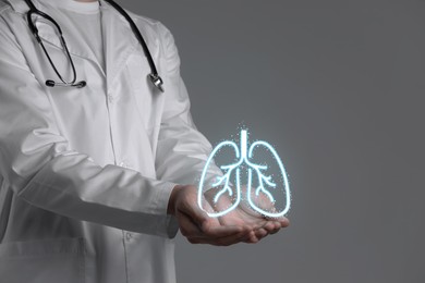 Image of Doctor holding virtual lungs on grey background, closeup