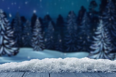 Image of Wooden table with snow in forest, space for text