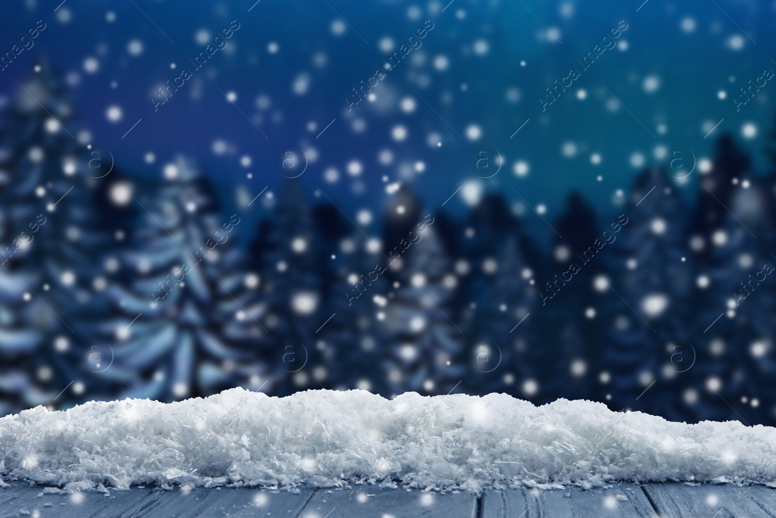 Image of Wooden table with snow in forest, space for text