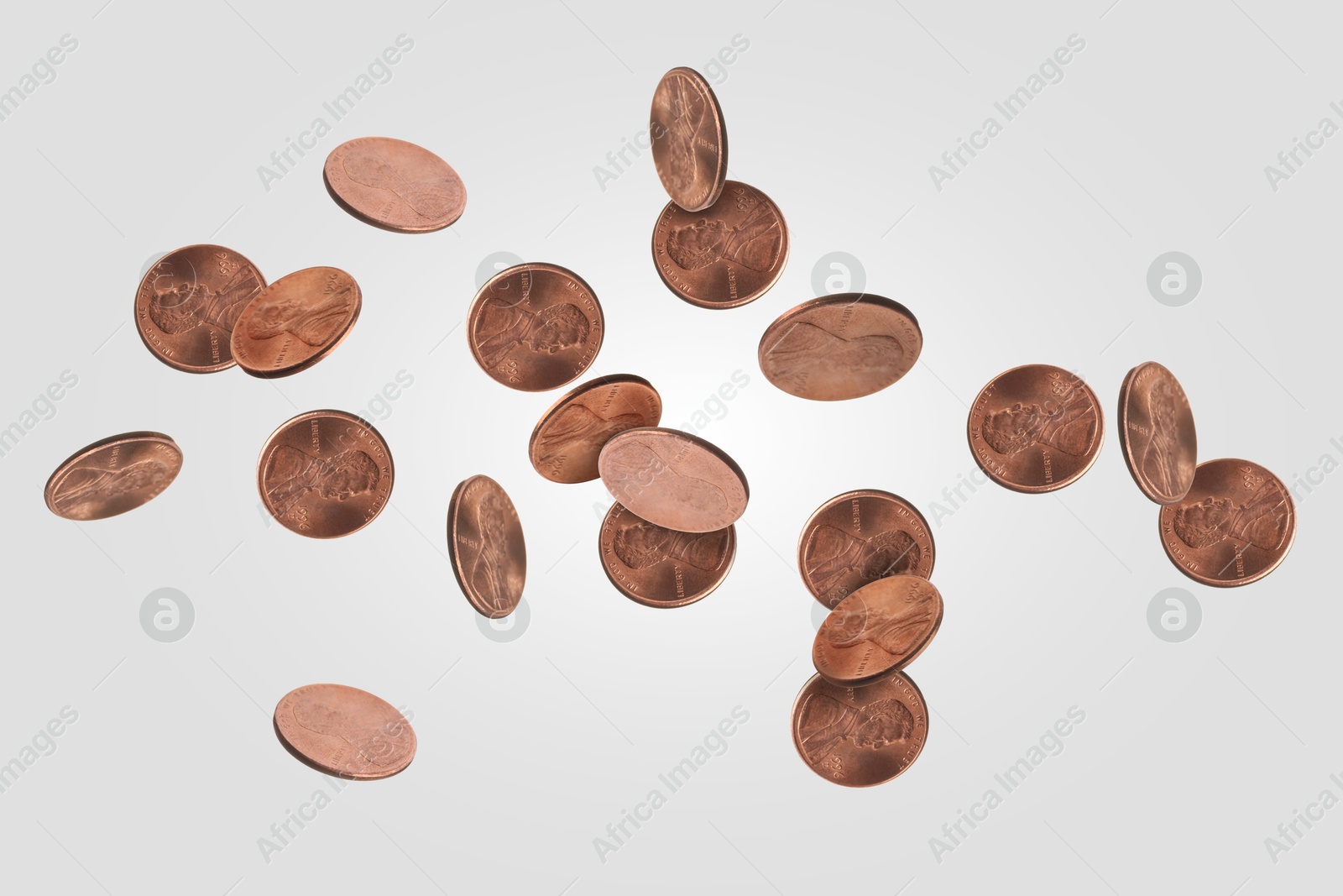 Image of United States one cent coins in air on light grey background