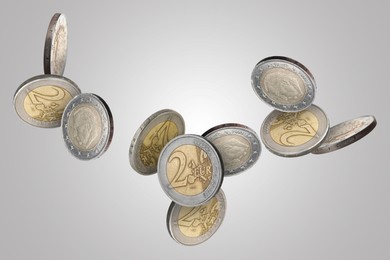 Euro coins in air on light grey background