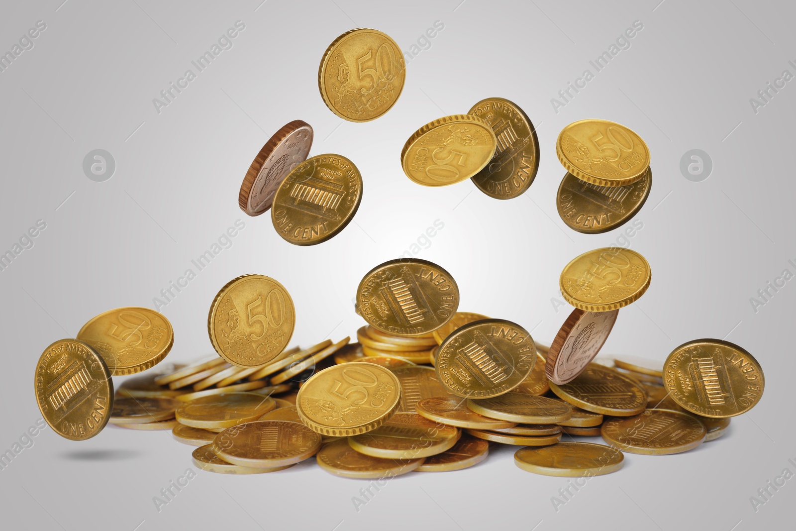 Image of Many coins falling on light grey background