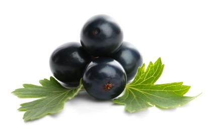 Photo of Ripe blackcurrants and green leaves isolated on white