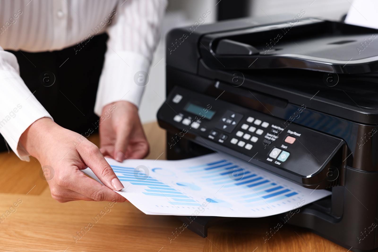 Photo of Woman using modern printer at workplace indoors, closeup