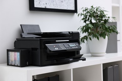 Modern printer on white table in office