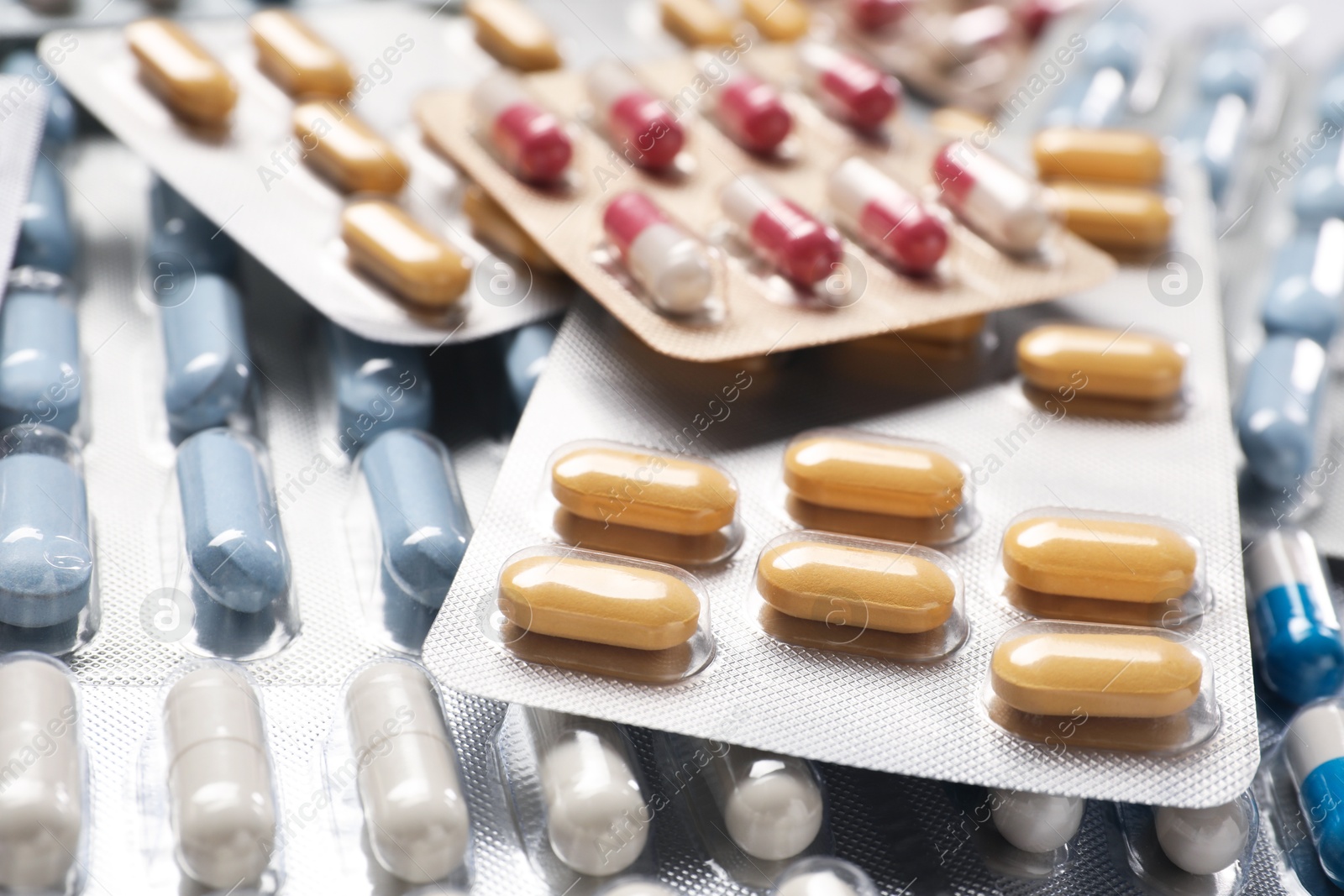 Photo of Antibiotic pills in blisters as background, closeup