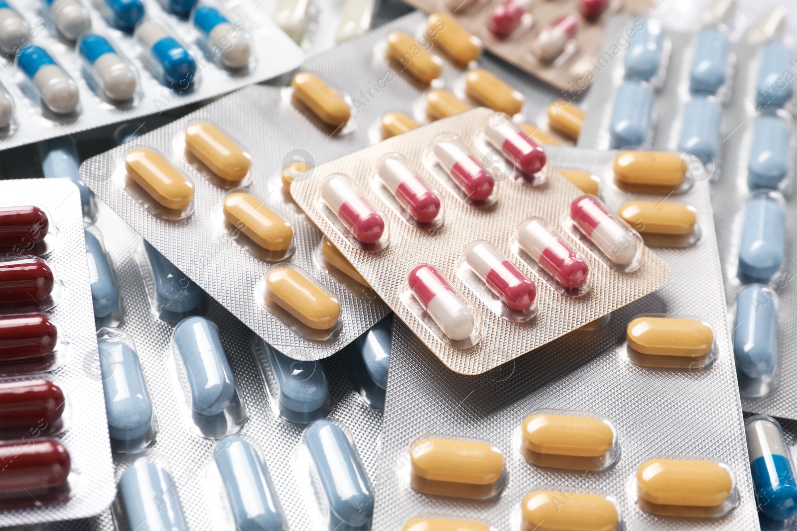 Photo of Antibiotic pills in blisters as background, closeup