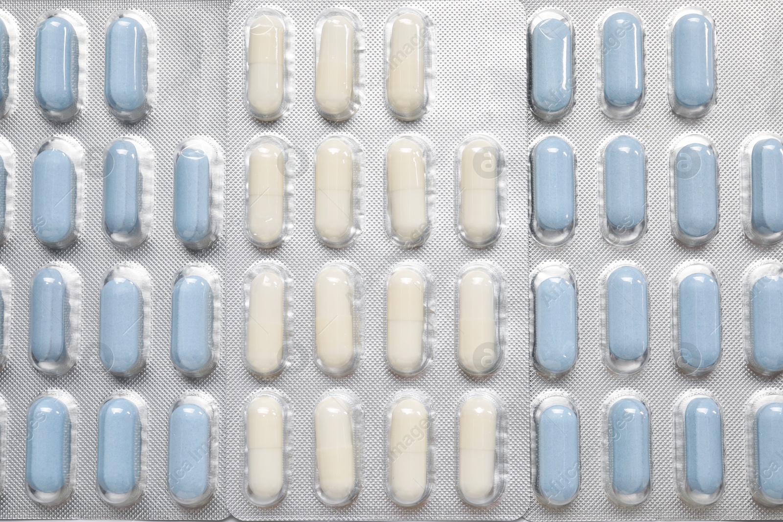 Photo of Antibiotic pills in blisters as background, top view