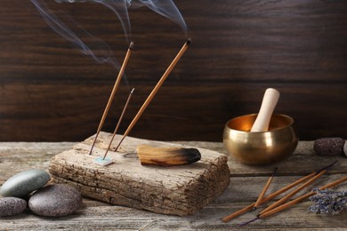 Aromatic incense sticks smoldering on wooden table