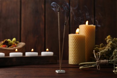 Aromatic incense sticks smoldering on wooden table