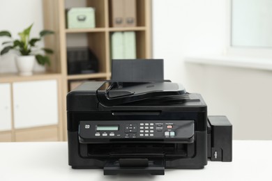 Photo of Modern printer on white table in office