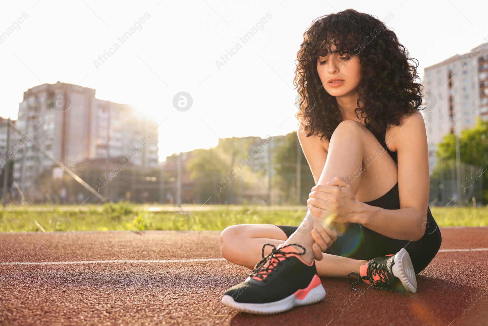 Photo of Sportswoman with leg injury at stadium, space for text