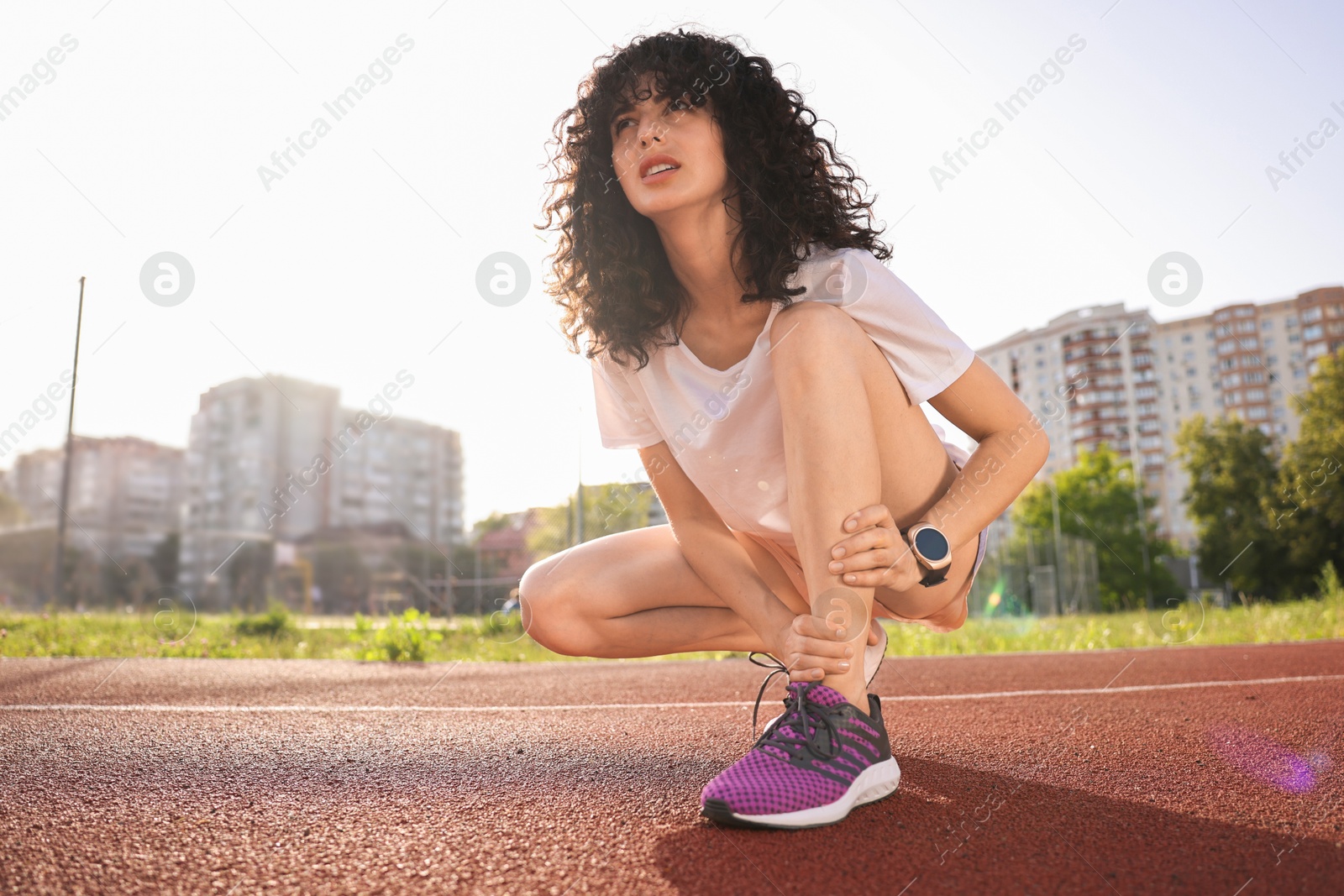 Photo of Sportswoman with leg injury at stadium, low angle view. Space for text