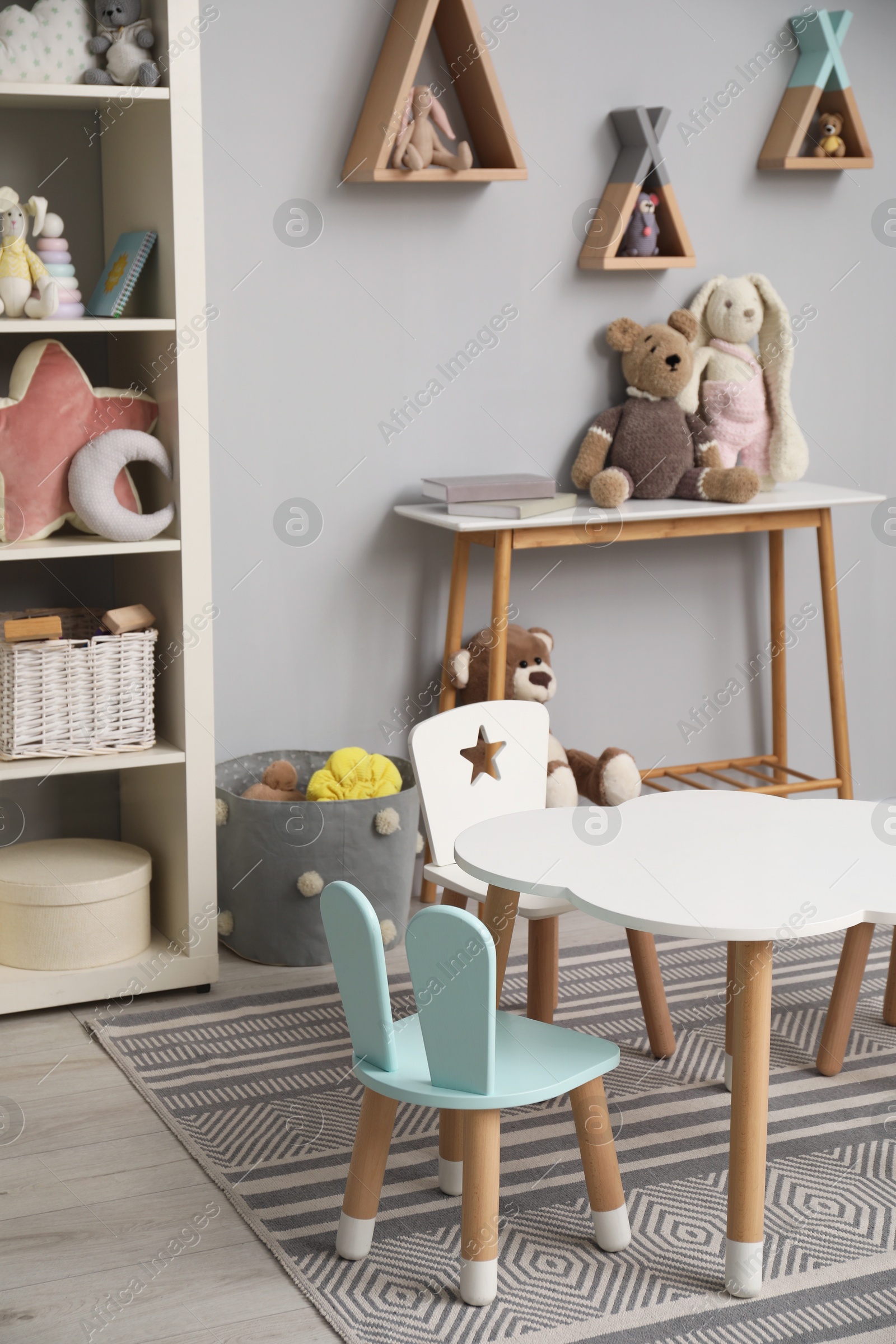 Photo of Stylish child room interior with modern furniture and toys