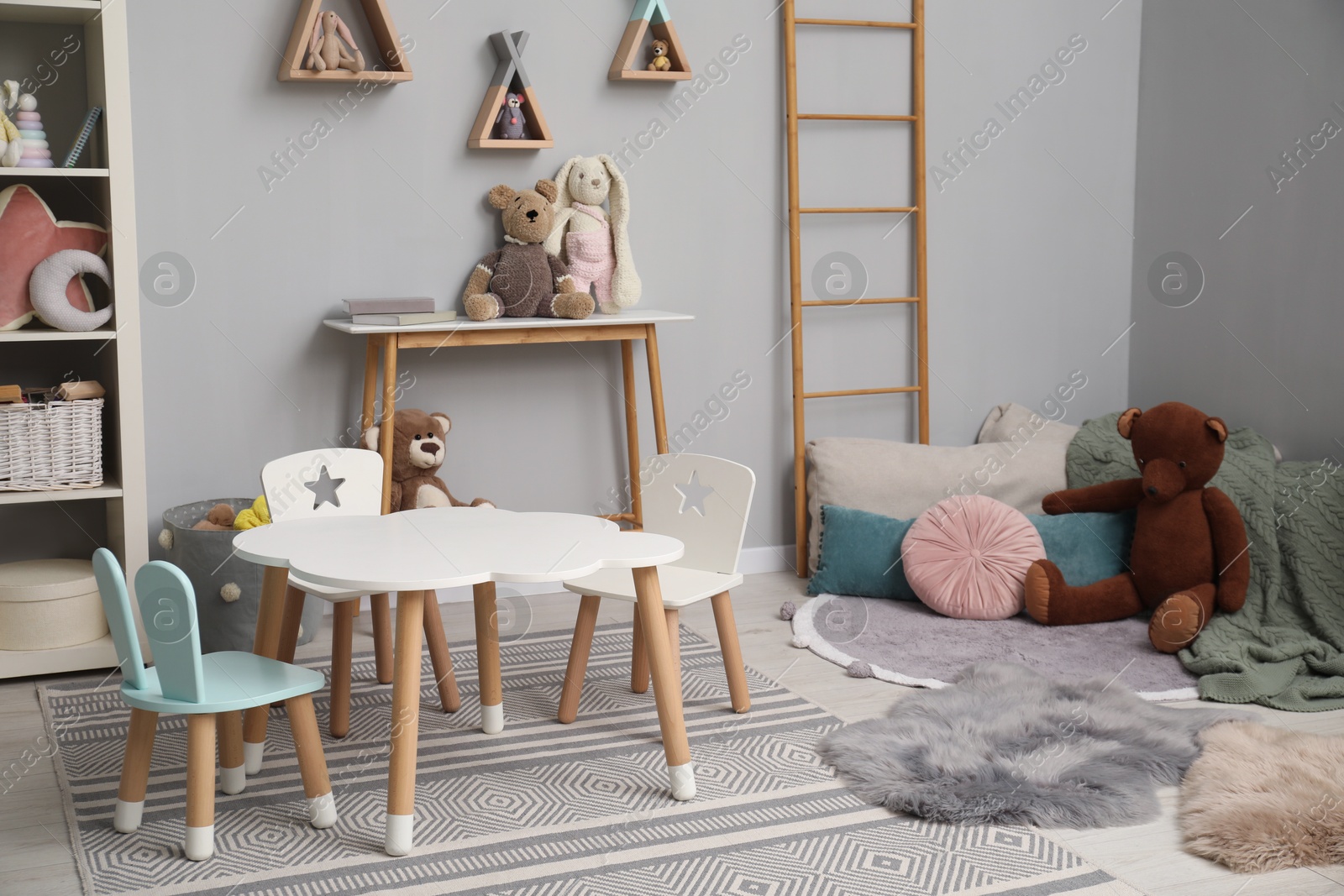 Photo of Stylish child room interior with modern furniture and toys