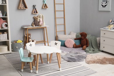 Stylish child room interior with modern furniture and toys