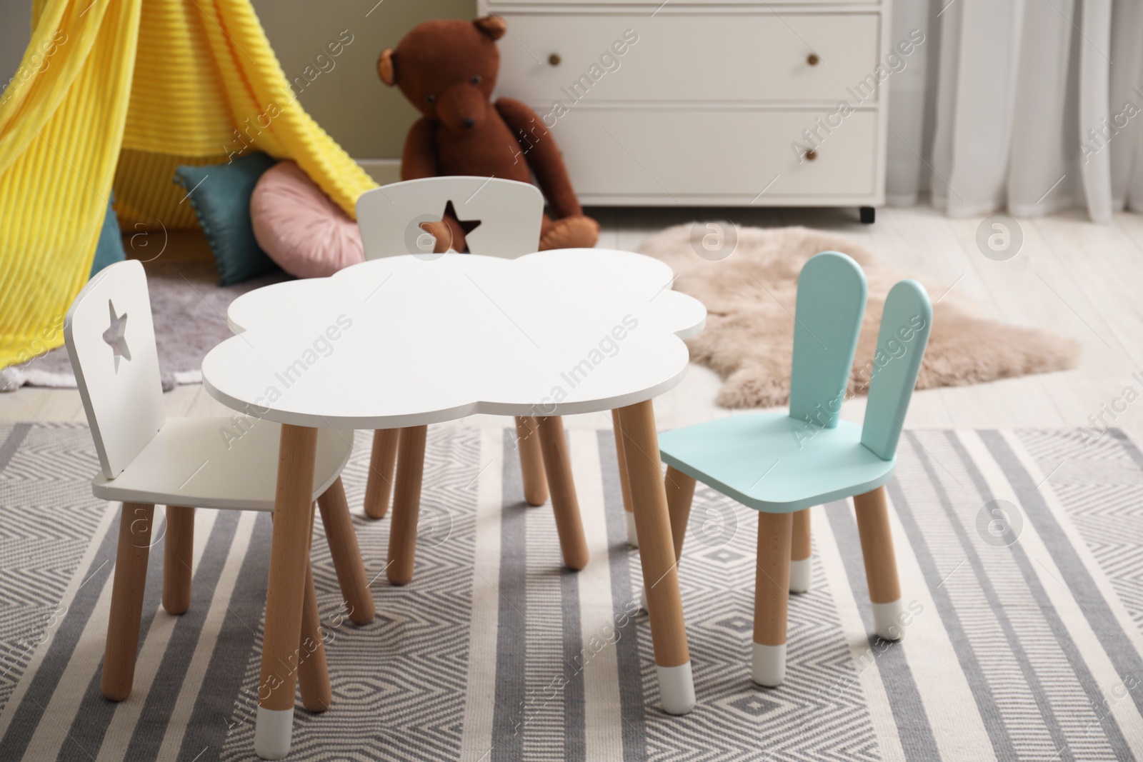 Photo of Stylish child room interior with table and chairs