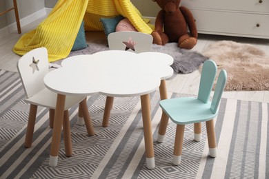 Photo of Stylish child room interior with table and chairs