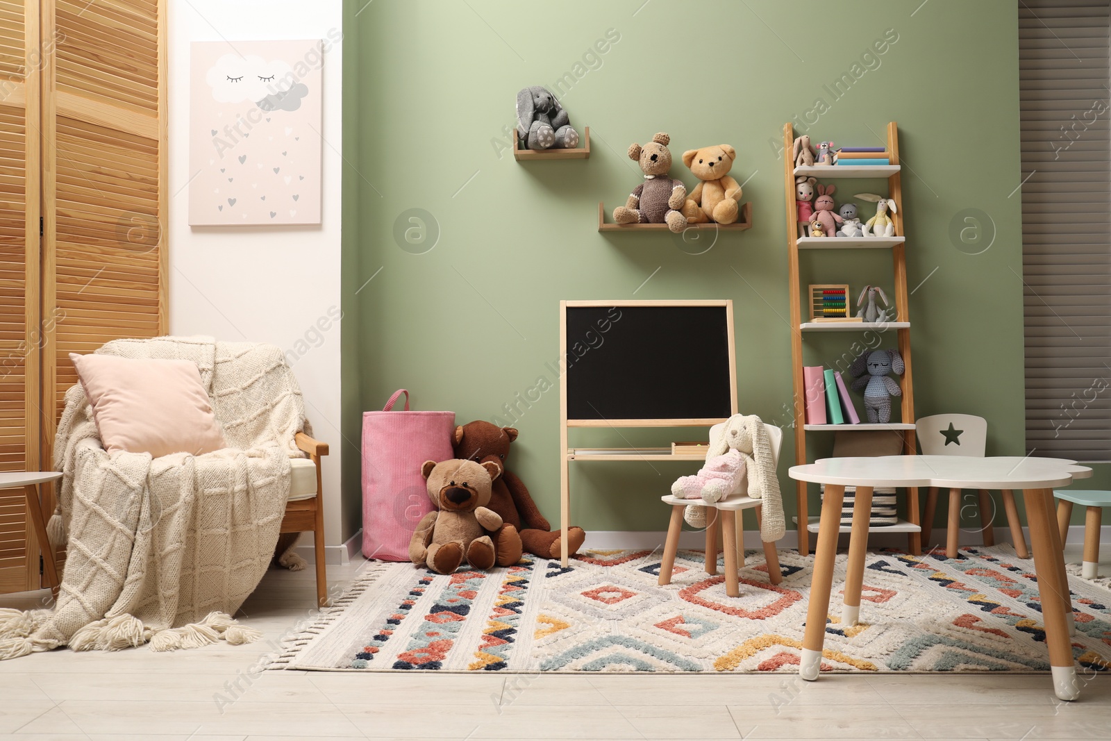 Photo of Stylish child room interior with different toys and furniture