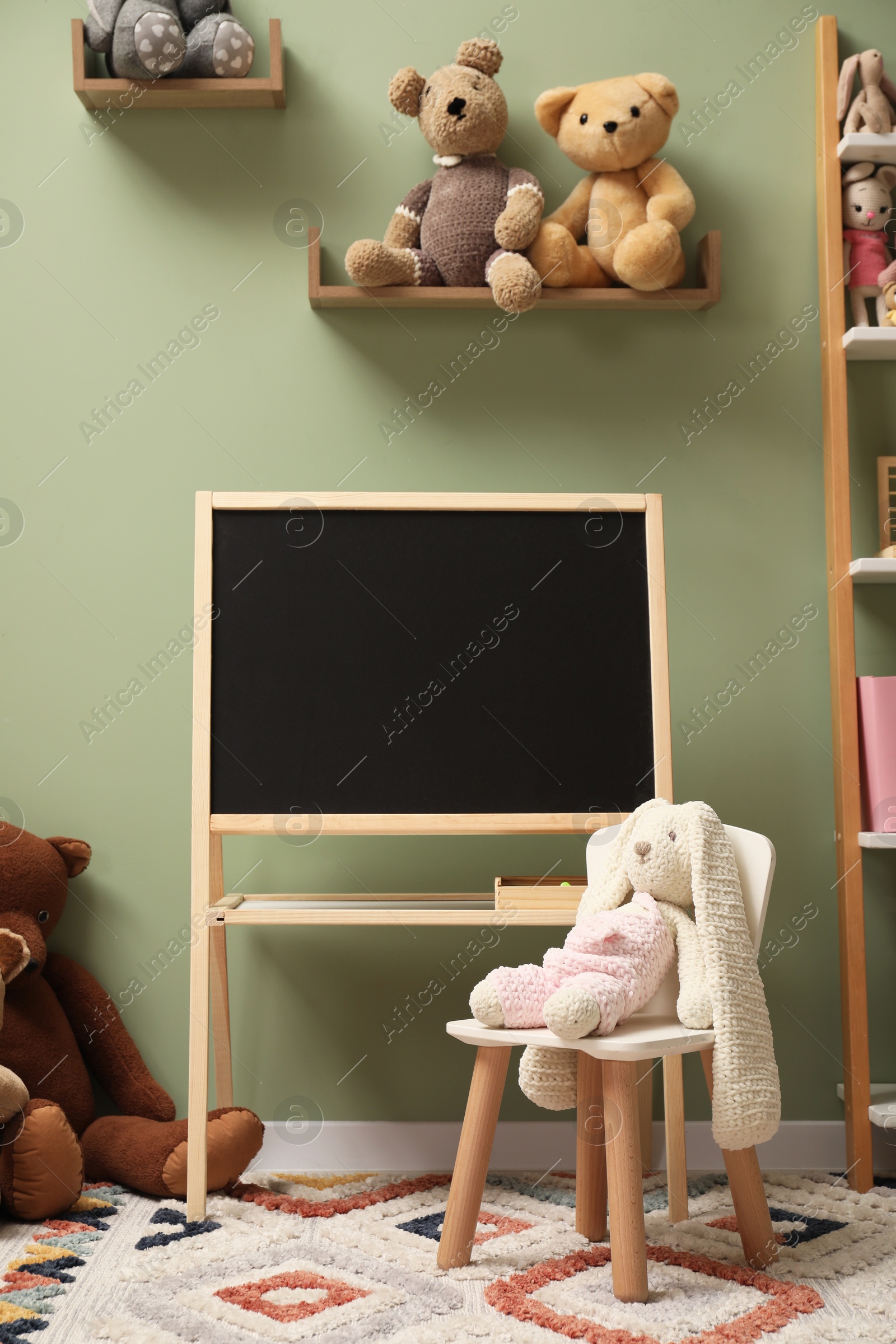 Photo of Stylish child room interior with different toys and furniture