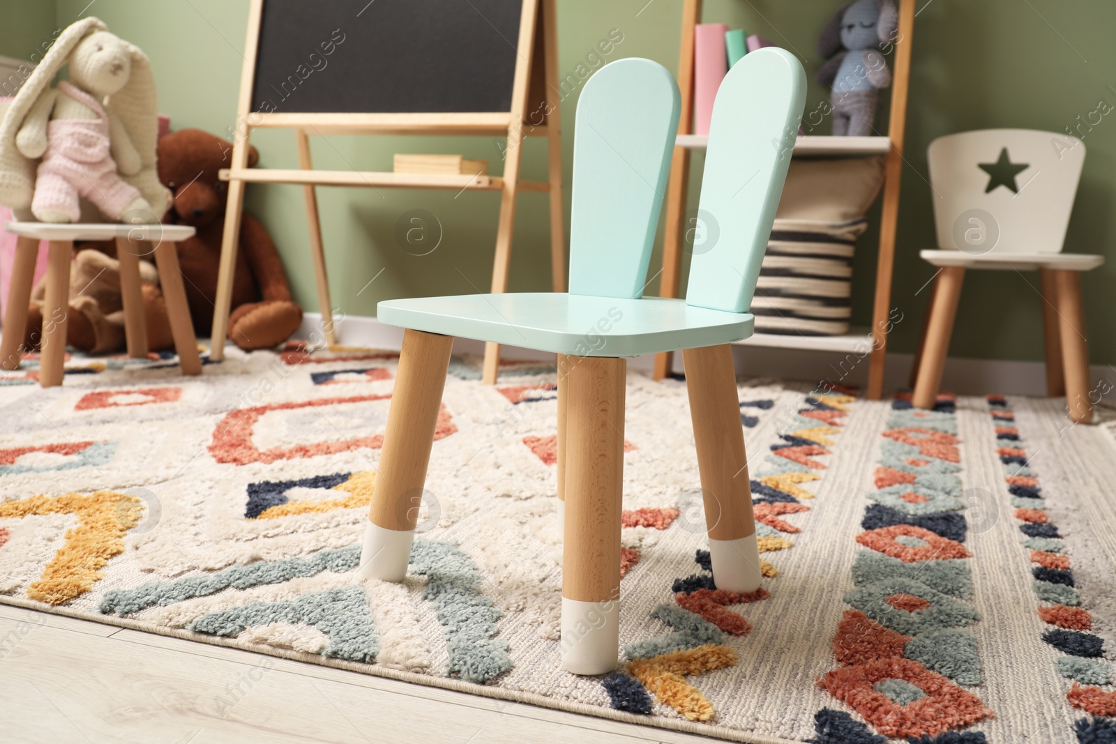 Photo of Stylish child room interior with different toys and furniture