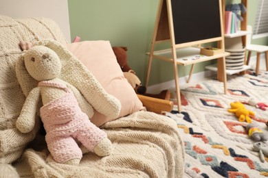 Photo of Stylish child room interior with different toys and furniture