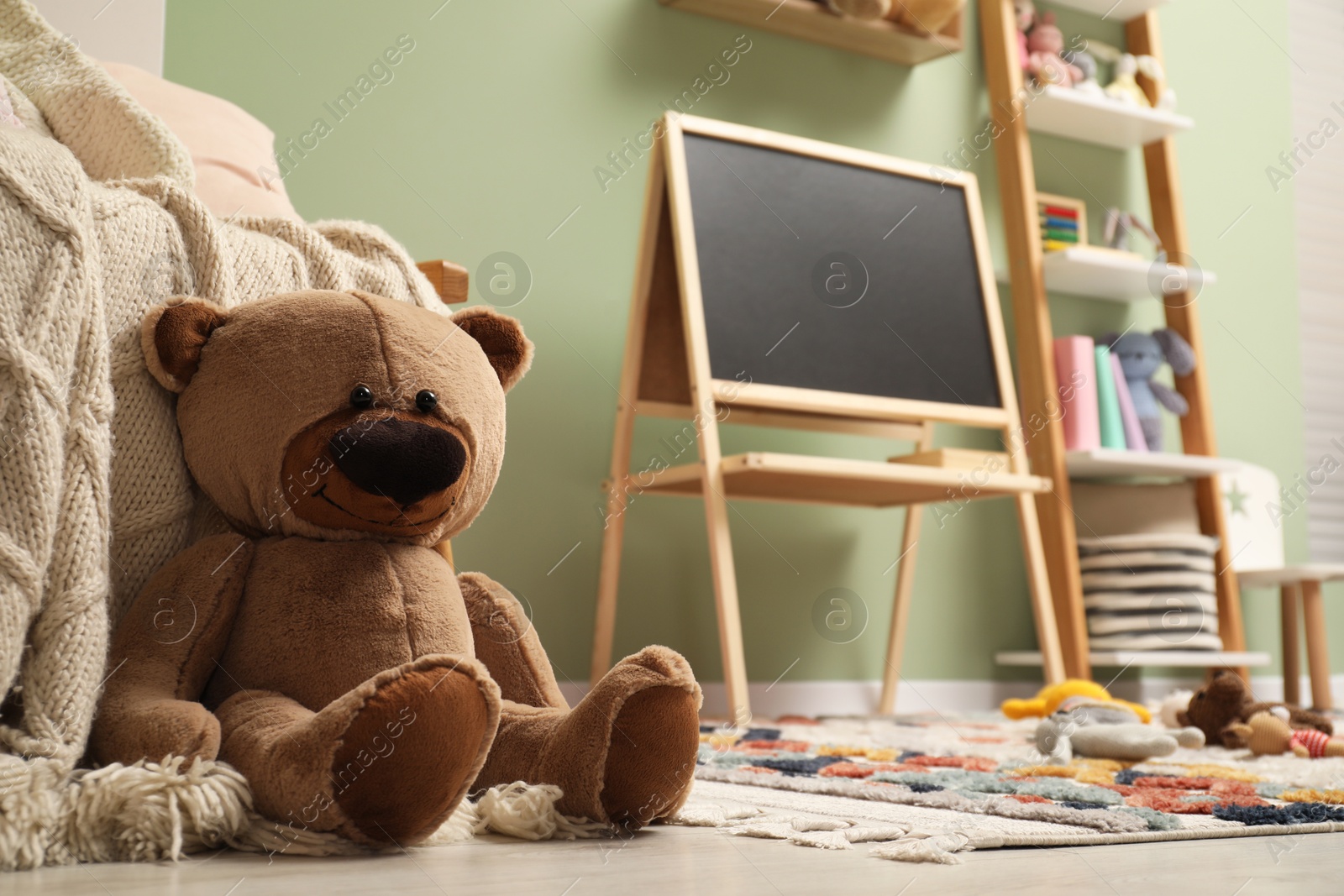 Photo of Stylish child room interior with different toys and furniture