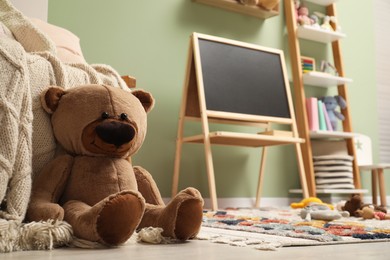 Stylish child room interior with different toys and furniture