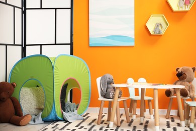 Photo of Stylish child room interior with different toys and furniture