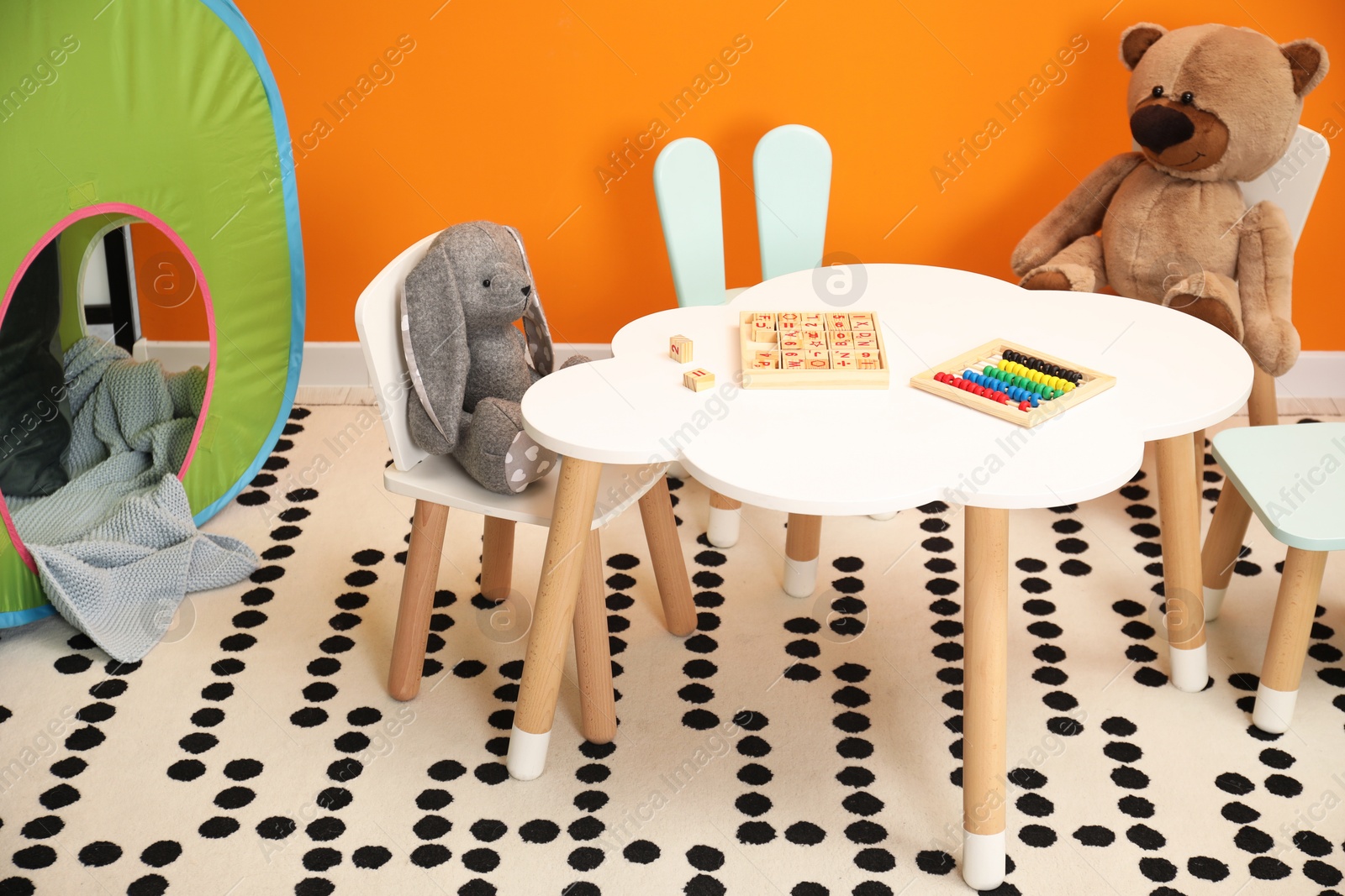 Photo of Stylish child room interior with different toys and furniture