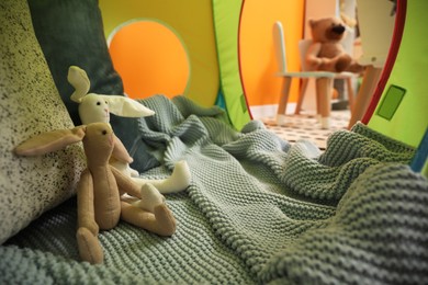 Photo of Play tent with cute bunny toys in child room